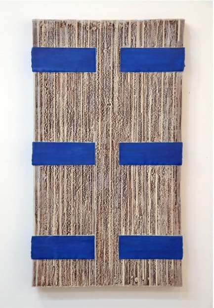 A blue strip on the wall is made of wood.