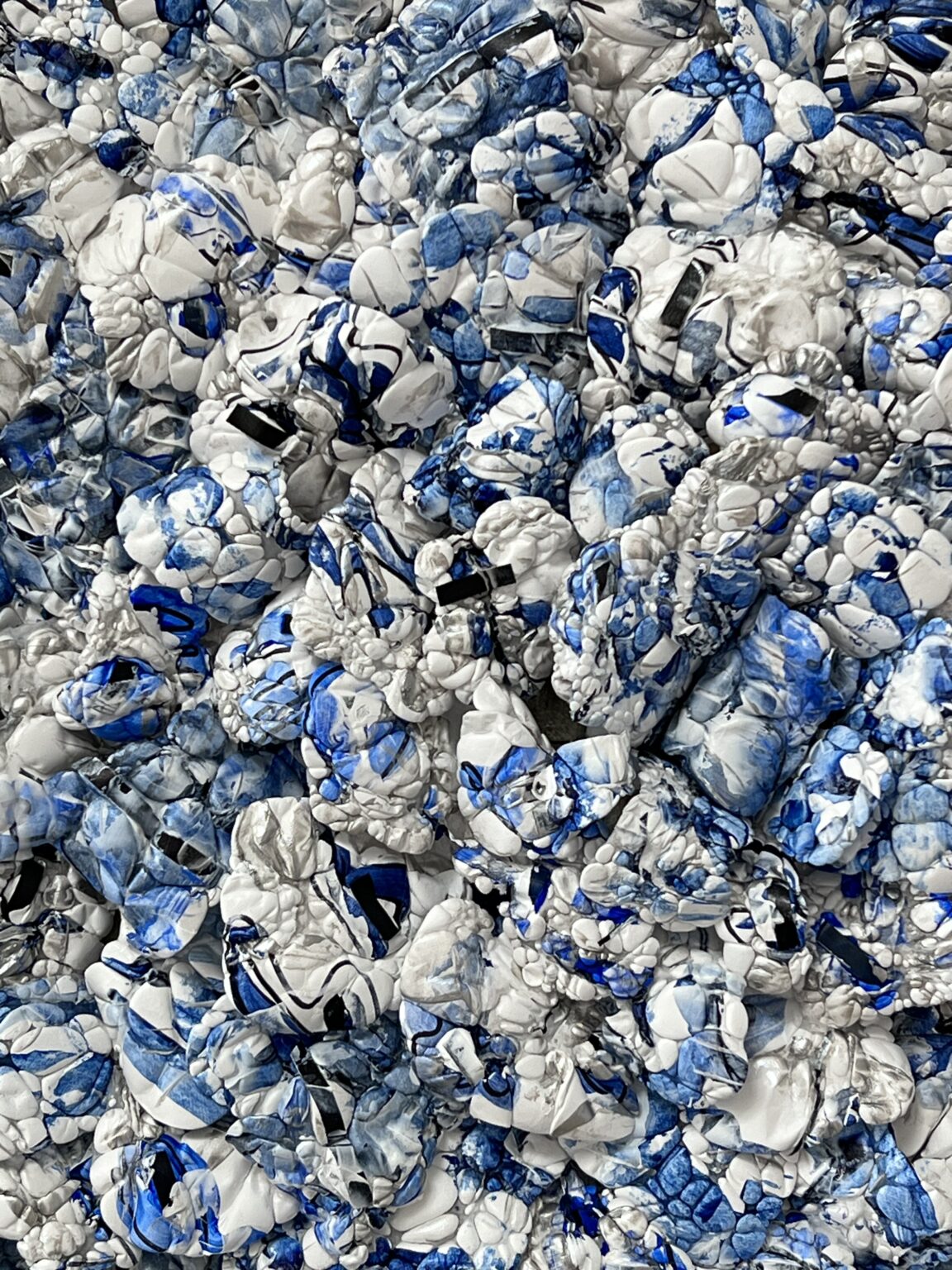 A pile of crushed cans in blue and white.